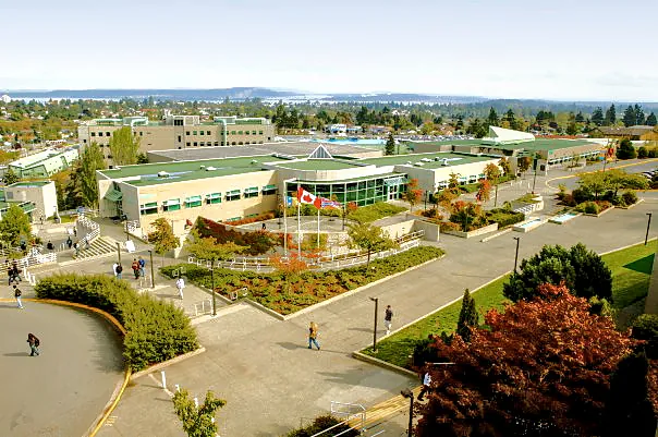 Aerial view of Vancouver Island University campus surrounded by forest in Nanaimo