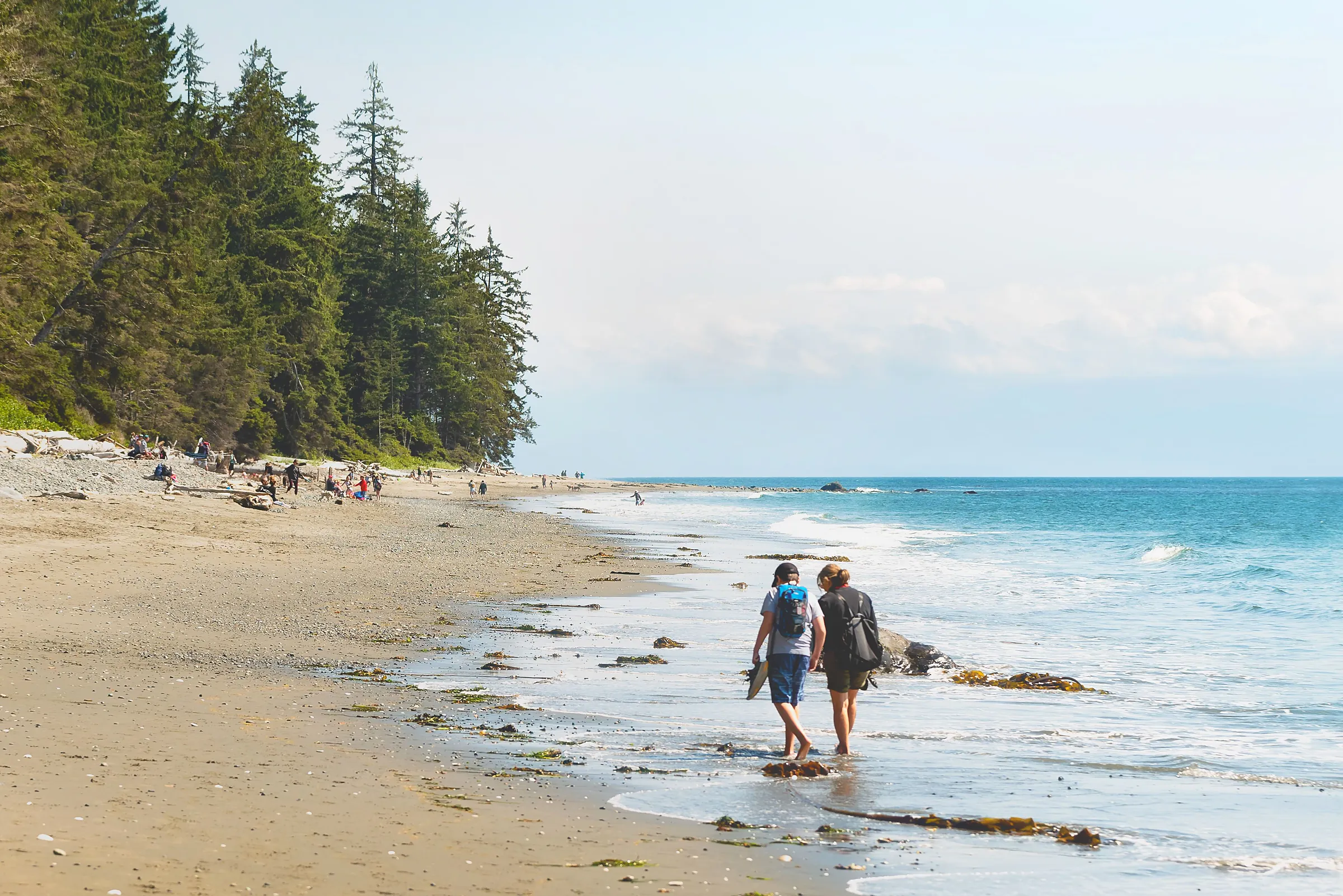 An international student group walking the wide sandy beach at low tide in Qualicum Beach
