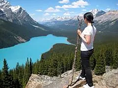 A student overlooking a turquoise alpine lake on Vancouver Island