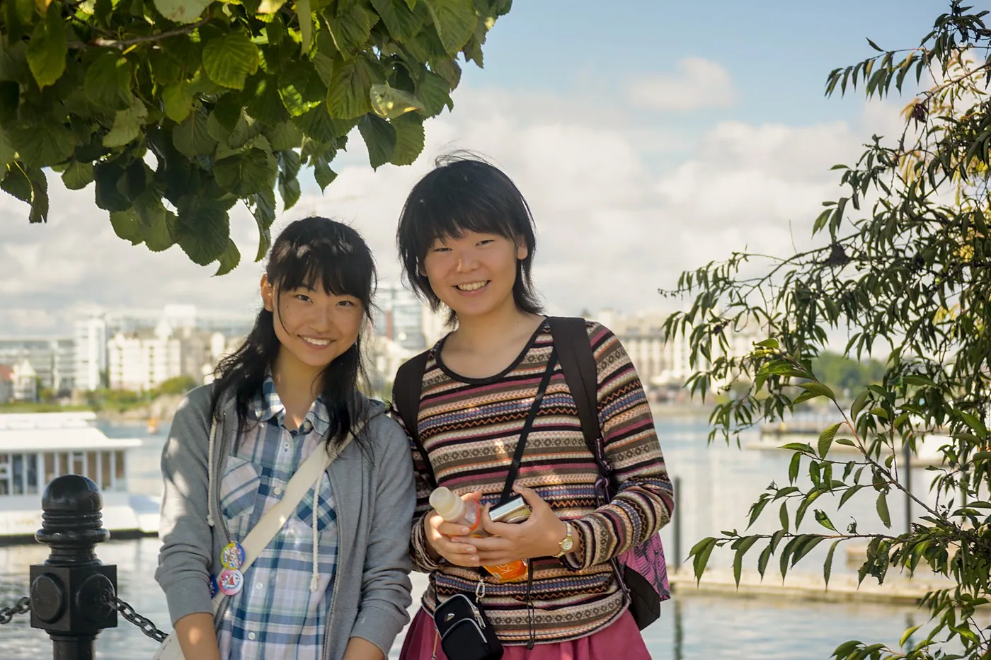 An international student group on the Inner Harbour causeway with the Parliament Buildings behind them
